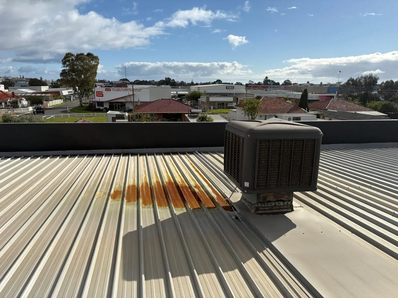 Rust staining on metal roof sheeting below an evaporative cooler